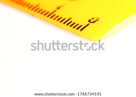 yellow rulers drawing isolated on a white background. macro shot.
