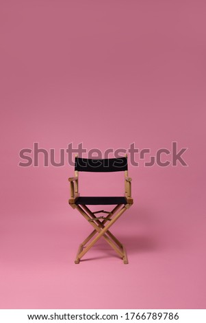 director's chair on a pink background Royalty-Free Stock Photo #1766789786