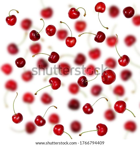 Falling Fresh cherries with stems background. Creative beautiful red ripe cherries summer berries pattern selective focus.    