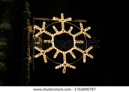 Beautiful illuminated snowflake shaped lantern on Christmas eve