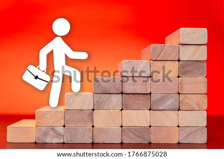 A businessman going up the ladder to success in a conceptual image over at the red background. The growth of a business concept and the path to success.