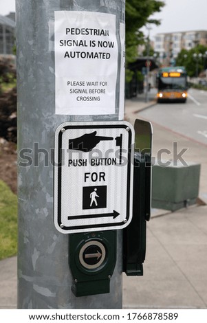 "Pedestrian signal is now automated" sign at a crosswalk