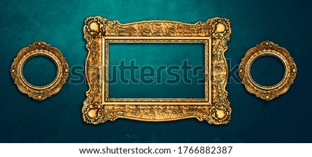 Vintage luxury golden frames set with ornate baroque decoration on rustic textured wall background. Retro fancy picture frames for interior design.
