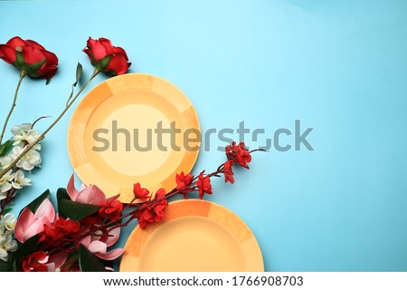 flt lay of plastic plate with flowers. food photography concept image