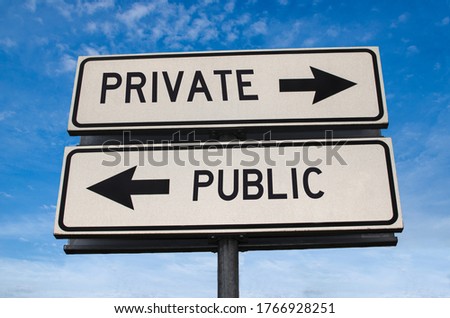 Private vs public. White two street signs with arrow on metal pole with word. Directional road. Crossroads Road Sign, Two Arrow. Blue sky background. Two way road sign with text.
