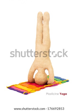 Plasticine yoga man in headstand asanaon a white background