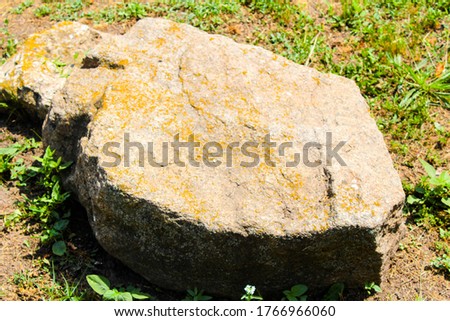Big stone near the road lies Ukraine