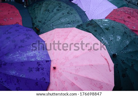 Umbrellas for the rain Different kind of umbrellas with different colors and textures are tested and sold in the streets of Asakusa, Tokyo, Japan. Royalty-Free Stock Photo #176698847