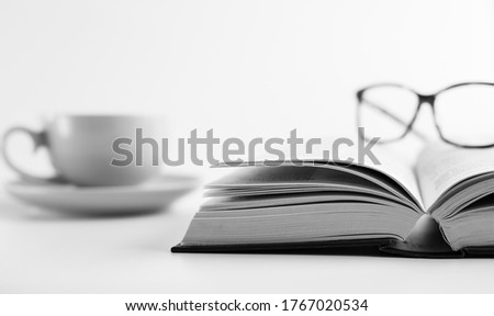 Open book, cup of tea coffee and reading glasses on white background. Learning from home. Self care, time away from technology, finding quiet place. Unplug yourself, time to calm the brain concept Royalty-Free Stock Photo #1767020534