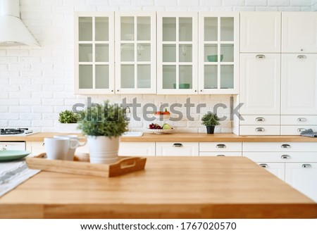 Kitchen wooden table top and kitchen blur background interior style scandinavian Royalty-Free Stock Photo #1767020570
