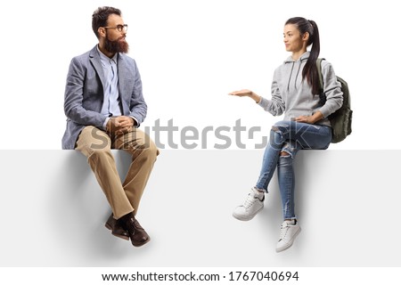 Female student sitting on a panel gesturing with hand and talking to a bearded man isolated on white background