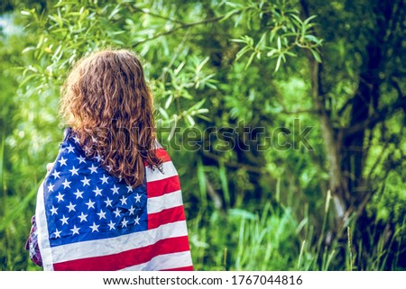 woman holding US flag independence day
