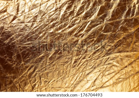 Texture of golden metalized fabric as abstract background