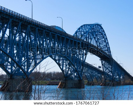 A bridge over blue water.