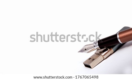 Fountain pen lies on a USB flash