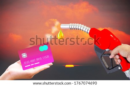 Fuel nozzle Hand holding Oil extracted from the background, clipingpart Wifi credit card Using new system technology Blurred background