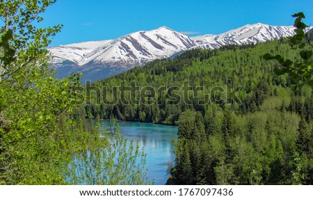 View of mountains by the Kenai river covered with snow in Alaska.