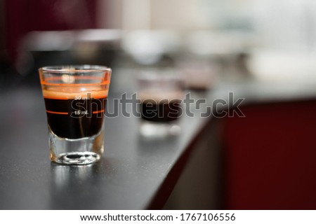 black coffee in measuring cup put on coffee tables