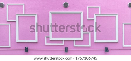 Wooden picture frames decorated on pink wall