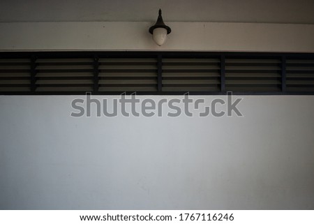 empty room  window on the white wall with lamp hanging on