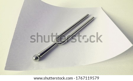Elegant minimalistic pitchfork on a white piece of paper.