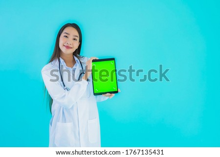 Portrait beautiful young asian doctor woman with stethoscope and smart tablet for use in hospital and clinic on blue isolated background