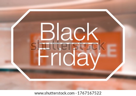 Blurred view of retail store sale display with Black Friday text overlay. Black Friday sale