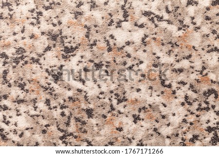 Abstract art background black, brown and gray color. Texture of stone tabletop and countertop with beige blotches, backdrop. Decorative wallpaper.