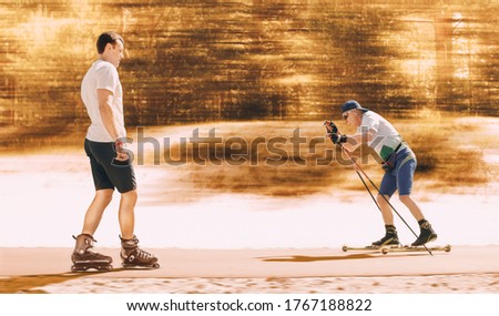 Young man roller skating and an elderly man roller ski