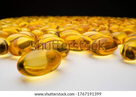 Close-up macro view of large group of fish oil capsules