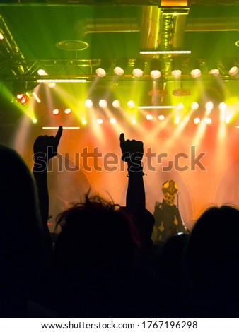 Concert photography during a gig,this is the point of view of the crowd in front of a stage during a music festival