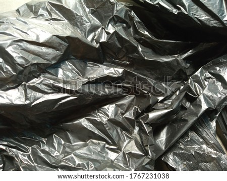 black shining polythene textured surface, abstract wallpaper, wrinkled background, back-cover designs for advertising or printing cover