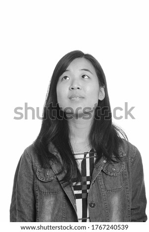 Portrait of young beautiful Asian businesswoman thinking