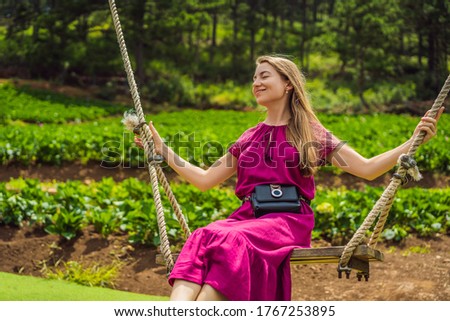 Woman on a swing in the garden