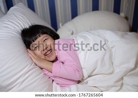 asian kid sleep on bed, happy child

