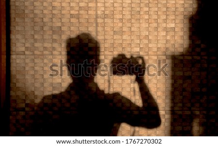 shadow of photographer reflected on wall