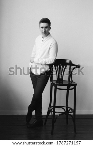 guy (boy or man), businessman, in a white shirt in a photostudio at home