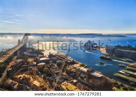 THe Rocks historic suburb of Sydney city from the altitude of high-rise tower over major Harbour waterfront landmarks.