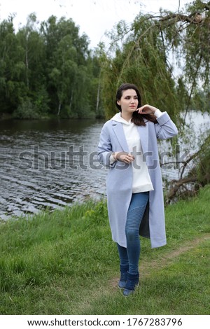 Portrait of a lovely young girl on a walk in the park