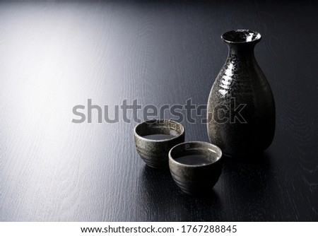 Sake containers on a black background with plenty of space