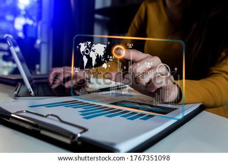 Double exposure of businesswoman working on digital laptop with digital marketing virtual chart, Abstract icon, Business strategy concept, Background toned image blurred.