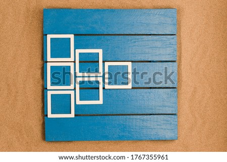 Blue wood and sea sand with mockup photo frames. space to write. Top view