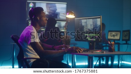 Medium shot of video editors working at their workstation