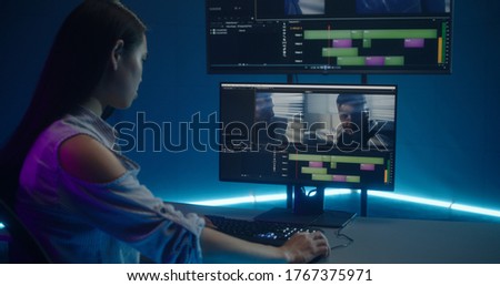 Medium shot of video editor working at her workstation