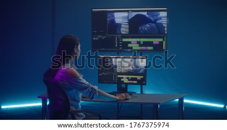 Medium shot of video editor working at her workstation