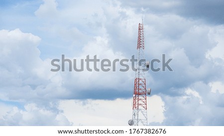 Wave transmission mast large phone signal with a bright blue sky.
