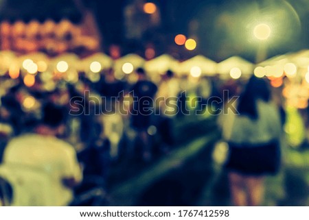 Vintage tone abstract blur image of Outdoor party in night time with light bokeh for background usage .