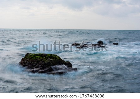 beauty moss area and small island on sunshine at the beach with magic light and violently wave of sea