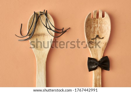 Cartoon family made up of farfalle pasta and wooden spoon, conceptual photography for food blog or ad