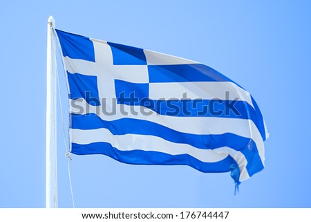 An image of the greek flag under a blue sky